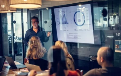 artica+i digitalización: imagen para ilustrar "Consultoría de redes y comunicaciones" dentro del servicio "Estudios de Madurez Digital. Consultoría TICS" mostrando a personas reunidas en una oficina ante una proyección virtual